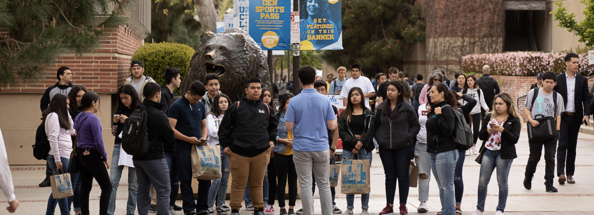 A group touring the campus on Bruin Walk