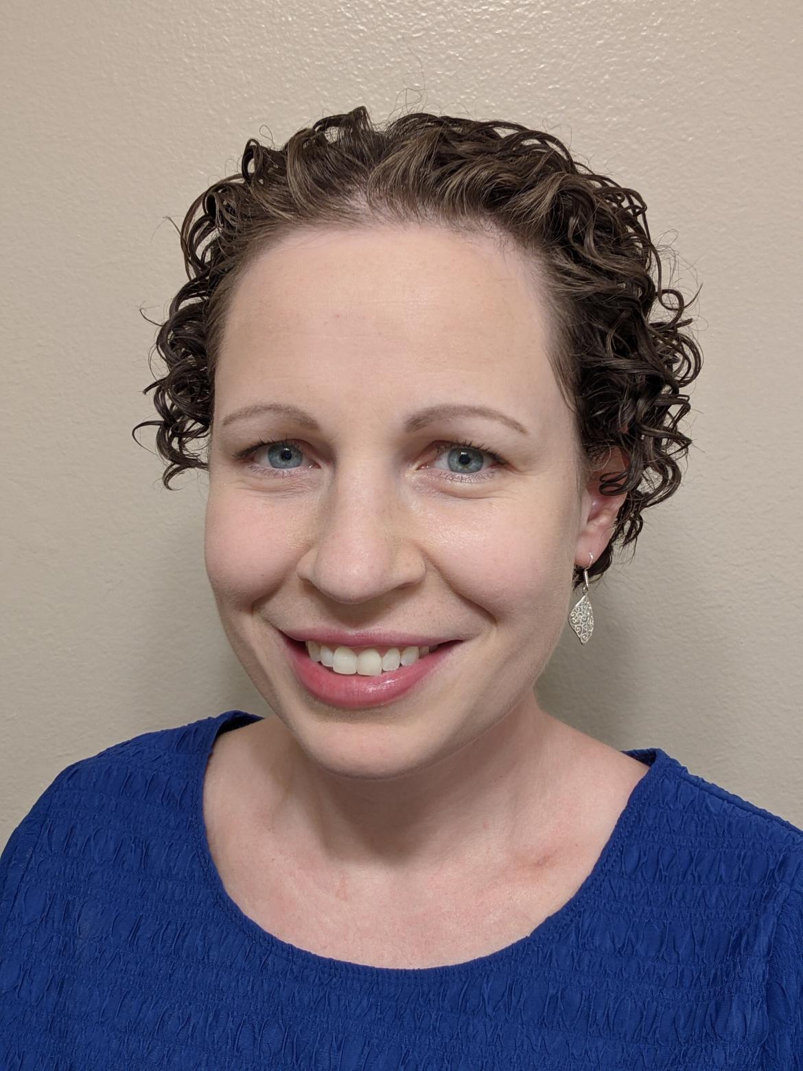 Therapist Jennifer Robles wearing a blue shirt smiling at the camera