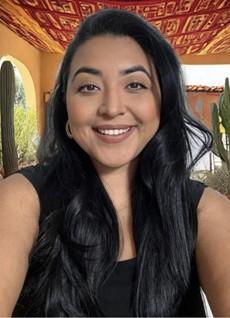 Intern Jasmine Reyna wearing a black shirt smiling at the camera